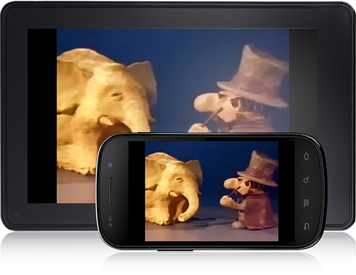 clay elephant approached by man in top hat and cape with a wand