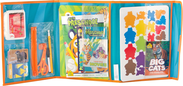 Jaz's Preschool Learning Pack unfolded with books, workbooks, flashcards, scissors, game boards, and more tucked into clear plastic sleeves