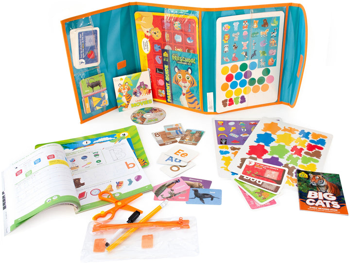 Jaz's Preschool Learning Pack unfolded with DVD, books, workbooks, flashcards, scissors, game boards, and more spread out