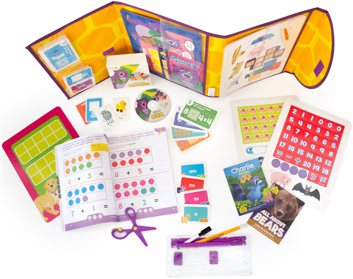  view from above of Oba's Kindergarten Learning Pack unfolded with DVD, books, workbooks, flashcards, scissors, game boards, and more spread out